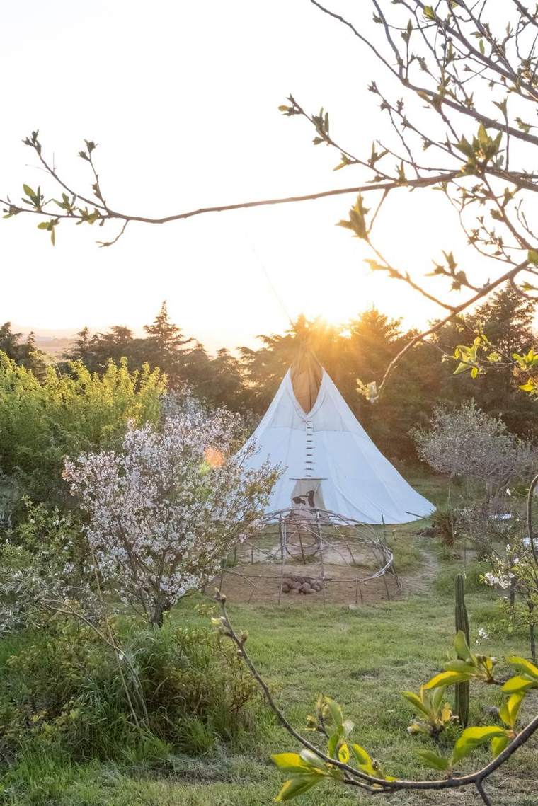 The teepee on the land at sunset